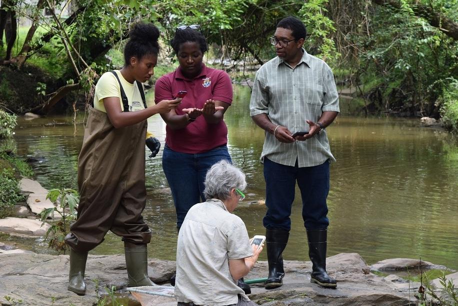 students standing near a creek