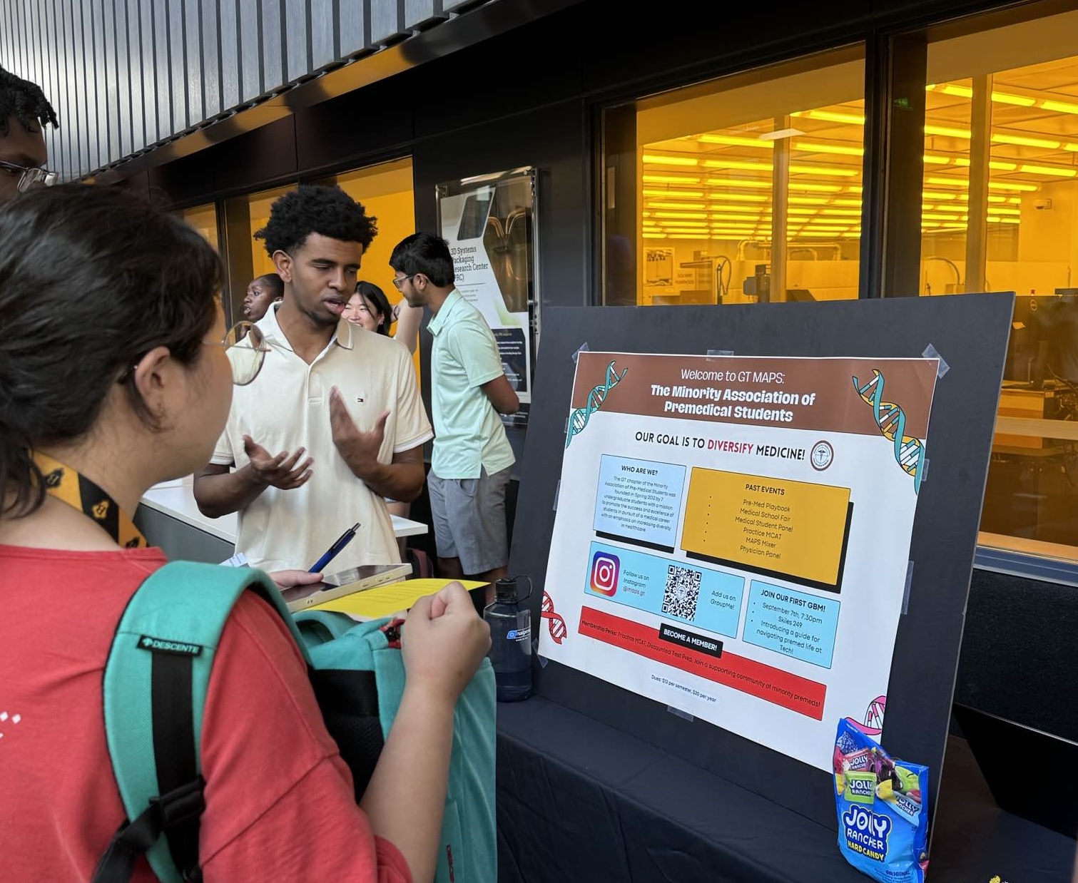 Students speaking at booths