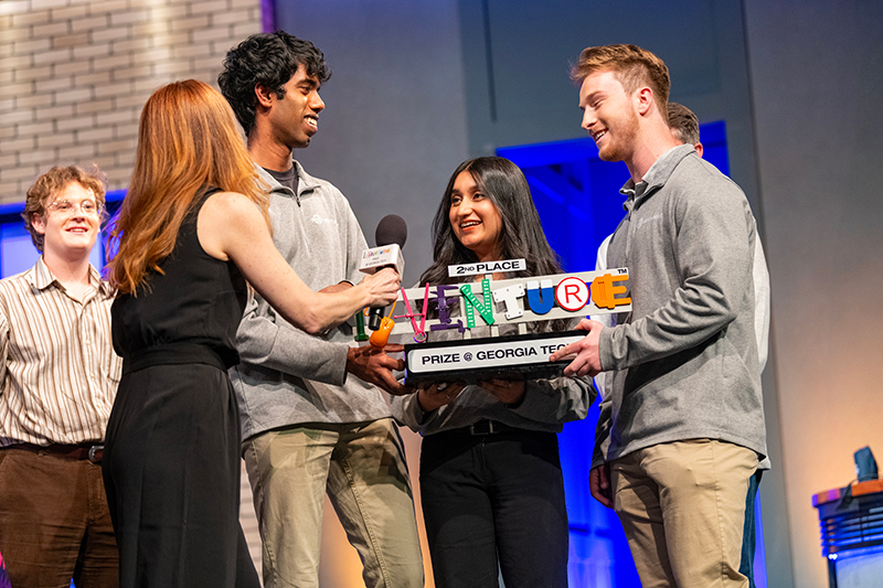 Runner up, NextGenFile, receives award onstage.