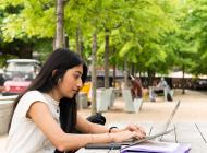 Student on her laptop on Skiles Walkway