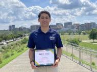 Said Gomez holding the Jack Mangham Experiential Learning Award.