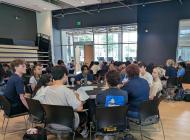 Students gather at tables to listen about different experiential learning programs.