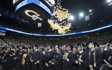 students celebrate with balloons at commencement