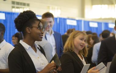Student stands in line at a career fair