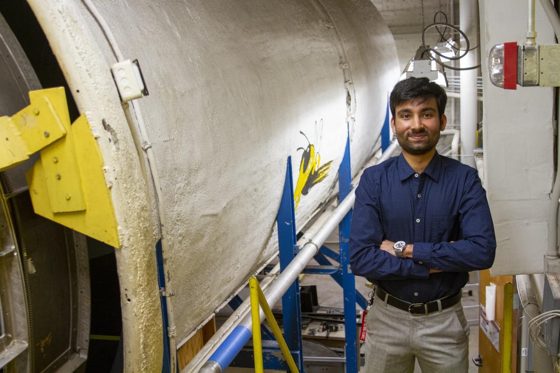 Yashvardhan standing in front of an air tunnel