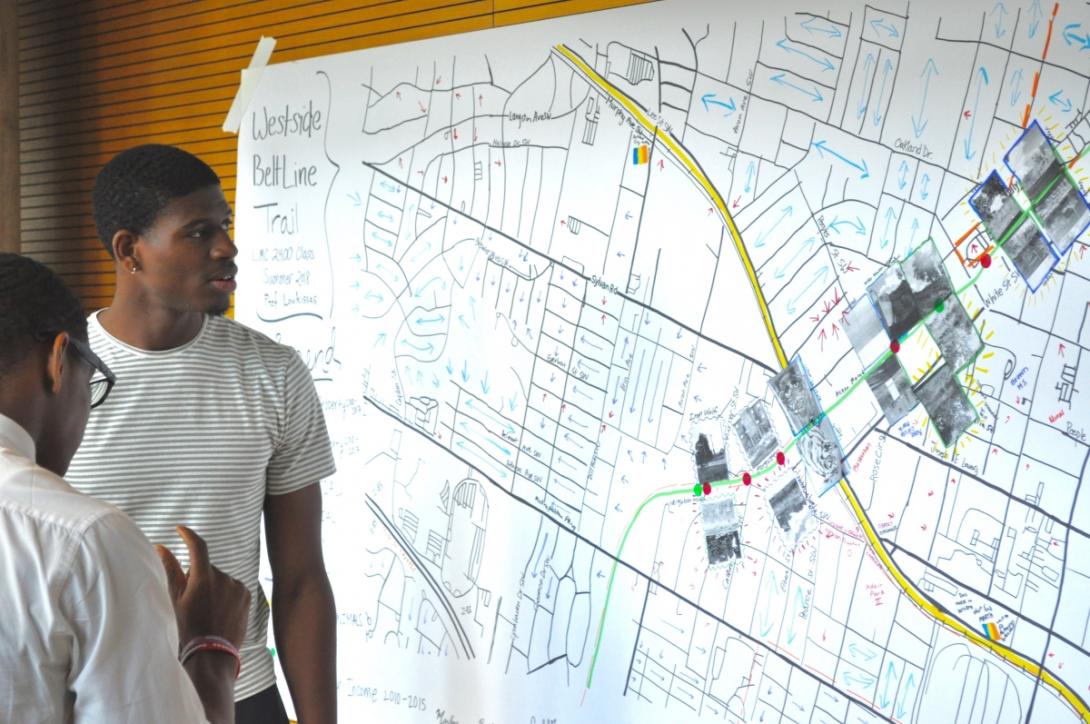 Students look at Dr. Yanni Loukissas’s LMC 2400 class project, which shows various aspects of the Westside Beltline Trail, created in the “Atlanta Map Room” 