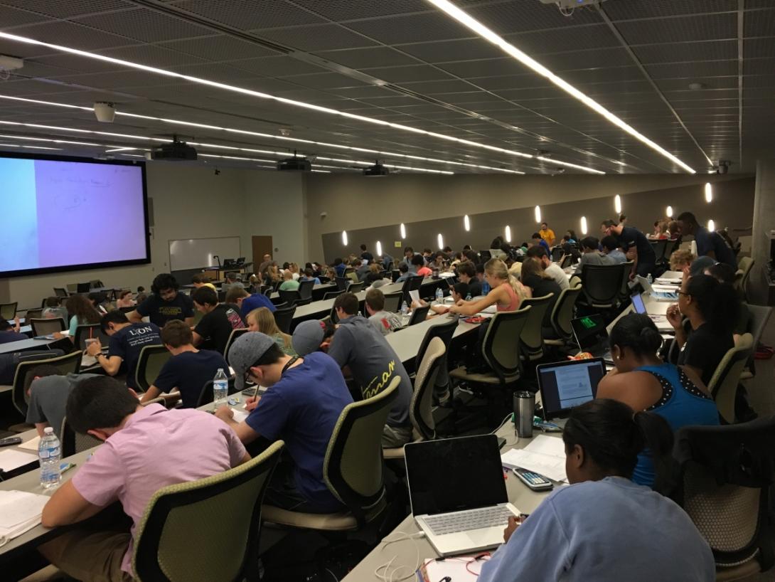 students studying in large classroom