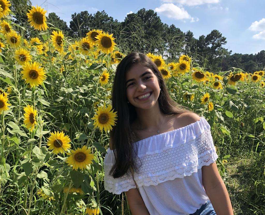 headshot of sophia in a sunflower field